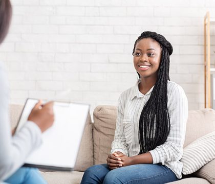 Positive results of therapy. Happy african american woman sitting at psychologist office after successful session, free space